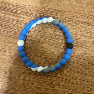 Blue, grey, and white Lokai bracelet​​​​​​​